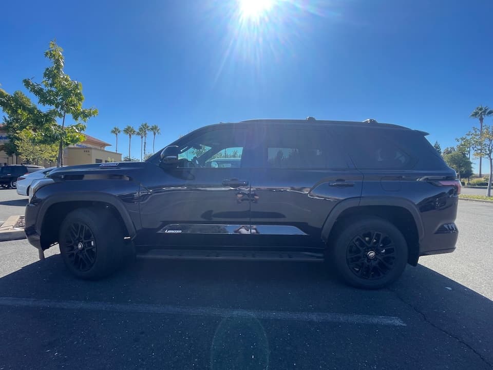 Dark blue 2026 Toyota Sequoia SUV, side profile in bright sun