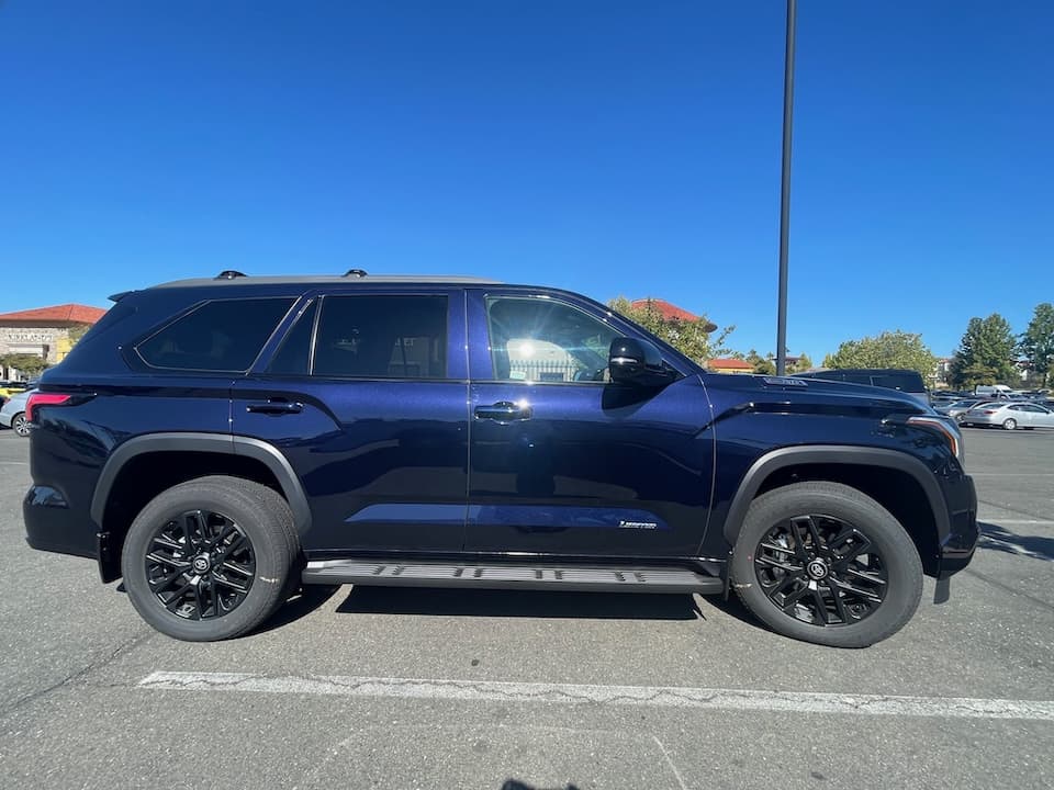 Dark blue 2026 Toyota Sequoia SUV, side profile in a parking lot